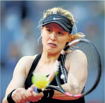  ?? CLIVE ROSE/GETTY IMAGES ?? Eugenie Bouchard hits a shot Wednesday during her victory over Angelique Kerber at the Madrid Open in Madrid, Spain. Bouchard was leading 6-3, 5-0 when Kerber retired with a thigh injury.