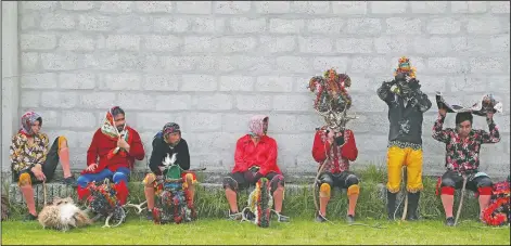  ??  ?? Performers rest after dancing in La Diablada Pillarena.