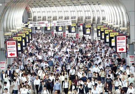  ?? BEHROUZ MEHRI/AFP ?? Commuters during rush hour at Shinagawa station in Tokyo. Japan’s workers spend more hours at the office than employees in almost any other country, but to avoid traffic chaos at next year’s Olympics authoritie­s have a message: stay home.