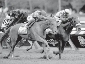  ?? AP /HANS PENNINK ?? V.E. Day (left), with jockey Javier Castellano aboard, moves past Wicked Strong and jockey Rajiv Maragh to win the Travers Stakes horse race Saturday at Saratoga Race Course in Saratoga Springs, N.Y. Both horses are trained by James A. Jerkens.