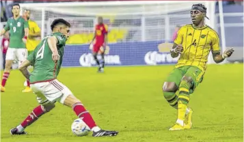  ?? (Photo: Richard Bell) ?? Jamaica’s Amari’i Bell (right) squares off against Mexico’s Edson Álvarez during the Concacaf Nations League match at Azteca Stadium in Mexico City in March 2023.