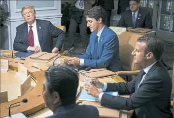  ?? NYT ?? Heads of state from the Group of Seven countries attend a working session Friday in La Malbaie, Quebec. From left are President Donald Trump, Canadian Prime Minister Justin Trudeau, French President Emmanuel Macron and Japanese Prime Minister Shinzo Abe.