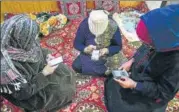  ?? ANI ?? People using their phones in Srinagar on Friday.