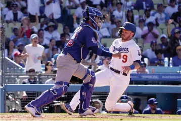  ?? AP Photo/Mark J. Terrill ?? Los Angeles Dodgers’ Gavin Lux, right, scores on a single by Freddie Freeman as Chicago Cubs catcher P.J. Higgins takes a late throw during the seventh inning Sunday in Los Angeles.