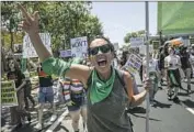  ?? Irfan Khan Los Angeles Times ?? THE GREEN bandanna, a symbol of Latin America’s abortion rights struggle, appears in L.A. in May.