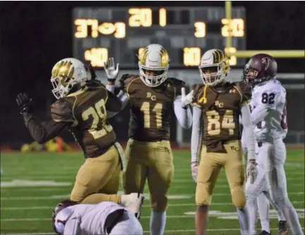  ?? THOMAS NASH - DIGITAL FIRST MEDIA ?? Bethlehem Catholic’s Zaccheus Brake (11) celebrates with teammates after tackling a Pottsgrove ball carrier during the third quarter of Friday night’s PIAA-4A playoff game.