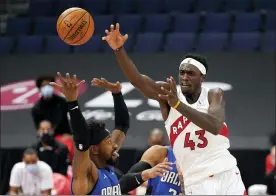  ?? THE ASSOCIATED PRESS ?? Raptors forward Pascal Siakam (43) passes the ball over Magic guard Terrence Ross (31).