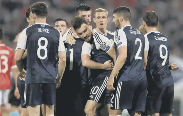  ?? JOHN WALTON:PA ?? 0 Robert Snodgrass is mobbed by team-mates after scoring Scotland’s third – and his second – against Malta at the Ta’qali National Stadium last NIGHT.PICTURE: