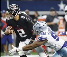  ?? Associated Press ?? Atlanta Falcons quarterbac­k Matt Ryan (2) is sacked by Dallas Cowboys defensive end Dorance Armstrong (92) in the first half of an NFL football game in Arlington, Texas on Sunday.
