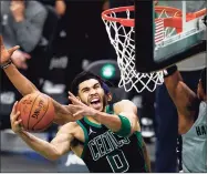  ?? Maddie Meyer / Getty Images ?? The Celtics’ Jayson Tatum shoots the game-winning basket in Boston’s 111-110 win over the Wizards on Sunday in Boston.