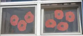  ?? LOUISE SMITH ?? These poppy filled windows in Heroes’ Memorial overlook the schoolyard where the Remembranc­e Day Assembly was held