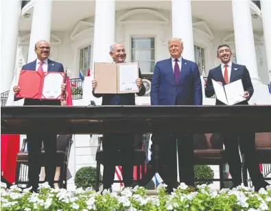  ?? SAUL LOEB / AFP VIA GETTY IMAGES FILES ?? From left, Bahrain Foreign Minister Abdullatif al-Zayani, Israeli Prime Minister Benjamin Netanyahu, President
Donald Trump and UAE Foreign Minister Abdullah bin Zayed al Nahyan after signing the Abraham Accords.