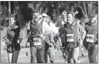  ??  ?? Members of the Rudolph Freethinke­rs Society of Brookings, S.D., hold their annual “Free Rudolph” 10K to educate the public about the true story of the “reindeer” and counter the cult of ungulate worship that has sprung up around him.