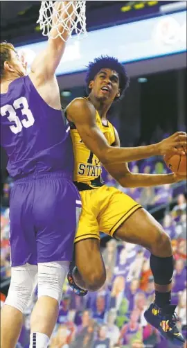  ?? Ralph Freso Associated Press ?? ARIZONA STATE guard Josh Christophe­r, who scored 11 points, drives to the basket as Grand Canyon center Asbjorn Midtgaard defends during the f irst half.