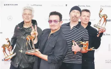  ??  ?? Clayton, Bono, the Edge and Mullen (left to right) of U2 pose with their Music Internatio­nal trophies during the Bambi 2014 media awards ceremony in Berlin on Nov 13, 2014. — Reuters file photo