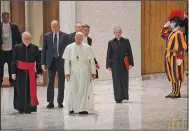  ?? (AP/Gregorio Borgia) ?? Pope Francis is shown with Vatican officials Monday in the Paul VI hall.