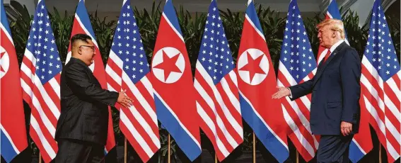  ?? Evan Vucci / Associated Press ?? President Donald Trump meets with North Korean leader Kim Jong Un on Sentosa Island in Singapore, a meeting he credits with saving tens of millions from nuclear war.