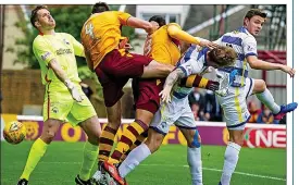  ??  ?? HEAD START: Charles Dunne (centre) opens the scoring for Motherwell