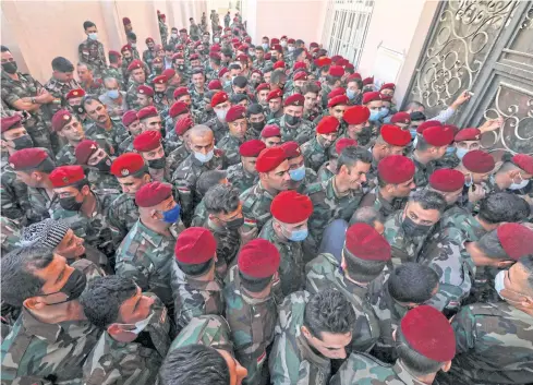  ?? AFP ?? Members of Kurdish Peshmerga security forces wait to cast their votes in Arbil, the capital of the northern Iraqi Kurdish autonomous region on Friday.