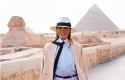  ?? CAROLYN KASTER/ASSOCIATED PRESS ?? U.S. first lady Melania Trump talks to members of the media as she visits the historic Giza Pyramids site near Cairo, Egypt, on Saturday. Her visit to Africa is her first internatio­nal trip without the president.