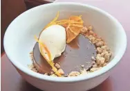  ?? MICHAEL SEARS, MILWAUKEE JOURNAL SENTINEL ?? The Diplomat's chocolate mousse, served with caramel whipped cream, pistachio streusel and orange chips.