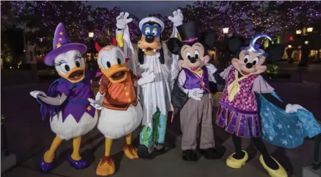  ?? JOSHUA SUDOCK, THE ASSOCIATED PRESS ?? Mickey Mouse and other characters dressed up for Halloween on Buena Vista Street at Disney California Adventure park in Anaheim, Calif.