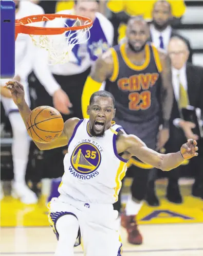  ?? Carlos Avila Gonzalez / The Chronicle ?? Kevin Durant, who scored 38 points, celebrates after a first-quarter dunk in the Warriors’ Game 1 victory.