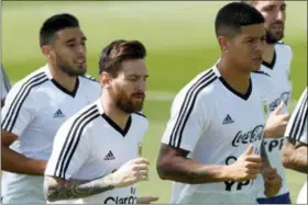  ?? RICARDO MAZALAN — THE ASSOCIATED PRESS ?? Marcos Rojo, right, and Lionel Messi jog during a training session of Argentina at the 2018 soccer World Cup in Bronnitsy, Russia, Thursday.