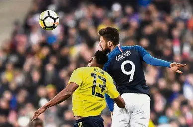  ?? — AFP ?? I got it: Colombia’s Yerry Mina (left) vying for the ball with France’s Olivier Giroud during the internatio­nal friendly match at the Stade de France on Friday.