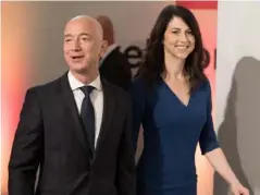  ?? (Getty) ?? Bezos and wife MacKenzie at publisher AxelSpring­er’s HQ in Berlin last April