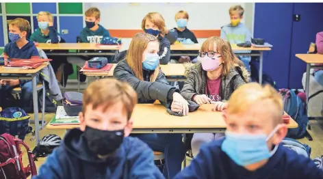  ?? FOTO: GREGOR FISCHER/DPA ?? Schüler einer sechsten Klasse tragen im Unterricht Masken.