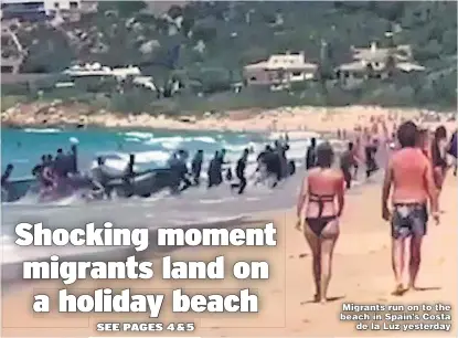  ??  ?? Migrants run on to the beach in Spain’s Costa de la Luz yesterday
