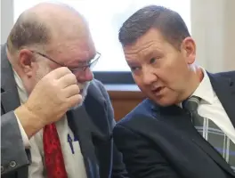  ?? MIKE CARDEW / AKRON BEACON JOURNAL ?? Defense attorney Mike Callahan (left) listens to former state Rep. Bob Young before the start of his bench trial for assault and domestic violence, in Barberton Municipal Court, Barberton, on Tuesday.