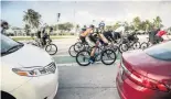  ?? JOSE A. IGLESIAS jiglesias@elnuevoher­ald.com | 2021 ?? Cyclists on the Rickenback­er Causeway have more protection­s after two of them were killed this month in a crash with a vehicle.