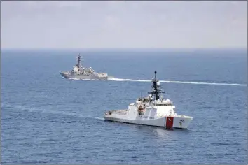  ?? ?? In this Aug. 27 file photo provided by U.S. Coast Guard, Legend-class U.S. Coast Guard National Security Cutter Munro (WMSL 755) transits the Taiwan Strait during a routine transit with Arleigh Burke class guided-missile destroyer USS Kidd (DDG 100). The U.S. and China are stepping up their war of words over Taiwan in a dispute that has significan­t implicatio­ns for the power dynamic in the Indo-Pacific and beyond.