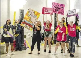  ?? Chris Dorst Charleston Gazette-Mail ?? ABORTION RIGHTS SUPPORTERS demonstrat­e Tuesday at the West Virginia state Capitol in Charleston as state senators debate the strict abortion bill.