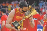  ?? MARK SCHIEFELBE­IN/ASSOCIATED PRESS ?? Marc Gasol of Spain celebrates with the trophy after beating Argentina 95-75 on Sunday to win the FIBA Basketball World Cup in Beijing.