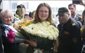  ?? ALEXANDER ZEMLIANICH­ENKO - ASSOCIATED PRESS ?? Russian agent Maria Butina, center, holds a bunch of flowers upon her arrival from the United States on Saturday at Moscow Internatio­nal Airport Sheremetye­vo outside Moscow.