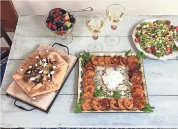  ?? AMY DEWALL DADMUN ?? Rustic apple onion tart, sweet potato corn cakes and spiralized Greek salad put vegetables front and center.