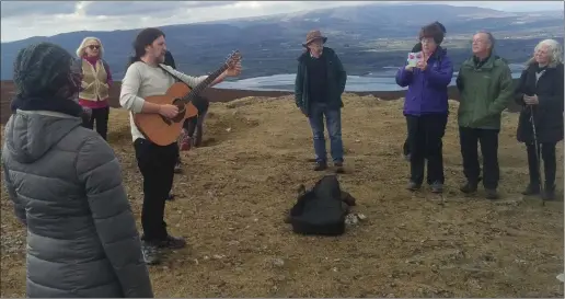  ??  ?? Seamie O’Dowd with family and friends of the late Thom Moore recall the singer/songwriter with music at Knocknarea last Saturday.