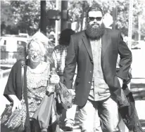  ?? Waco Tribune Herald via AP ?? Jacob Carrizal, right, the first biker to be prosecuted for his alleged role in the May 17, 2015, Twin Peaks shootout, heads to court with an unidentifi­ed woman on Oct. 11 in Waco, Texas.