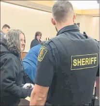  ?? ROSIE MULLALEY/THE TELEGRAM ?? Anne Kelly (left) prepares to be handcuffed and led out of the courtroom in provincial court in St. John’s Thursday after she was sentenced to four years in jail for armed robbery at a Shoppers Drug Mart in Mount Pearl two years ago.