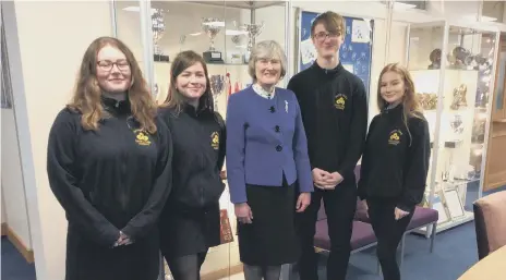  ??  ?? Former Foreign Senior Diplomat Dame Veronica Sutherland with students at Sawtry Village Academy sixth form.