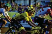  ?? PETE KIEHART / THE NEW YORK TIMES ?? Egan Bernal, (center) in yellow jersey, rides in the final stage of the Tour de France in Paris on Sunday. The 22-year-old became the first South American to win the Tour.