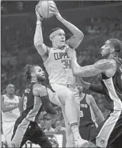  ?? Luis Sinco Los Angeles Times ?? CLIPPERS FORWARD Tobias Harris, who had 31 points, is fouled by the Spurs’ LaMarcus Aldridge.