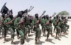  ?? AP ?? Deadly campaign Al Shabab fighters perform military exercises in the Lafofe area some 18km south of Mogadishu, Somalia. The group claims it has killed 20 Kenyan officers.