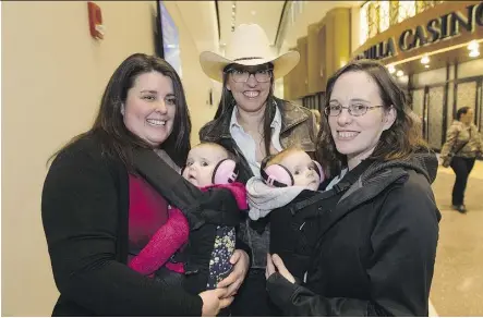  ??  ?? Garth Brooks fans Liz Ogston and daughter Zola, 10 months, Sherri Cummins and Melissa Dussault with daughter Aubree, six months, head into the first of the country-music icon’s nine Rogers Place shows Friday.