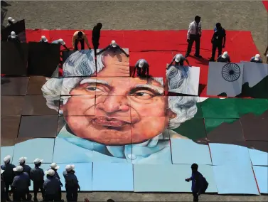  ??  ?? Schoolchil­dren piece together an image of former President A.P.J. Abdul Kalam during an event organised in Chennai to commemorat­e his 85th birth anniversar­y on Saturday. AFP