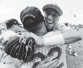  ?? THE ASSOCIATED PRESS ?? Texas infielder Kody Clemens, back, celebrates with head coach David Pierce (22) following the Longhorns’ win over Tennessee Tech on Monday.