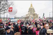  ?? ?? People stage a protest against the retirement bill in Paris, Monday, March 20, 2023. France’s government is fighting for its survival Monday against no-confidence motions filed by lawmakers who are furious that President Emmanuel Macron used special constituti­onal powers to force through an unpopular bill raising the retirement age from 62 to 64 without giving them a vote. Les Invalides in background. (AP)